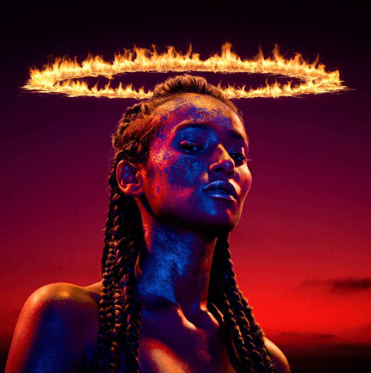 Portrait of a woman against a deep red sunset sky, her skin painted with cobalt and crimson pigments, a crown of living flame floating above her head.